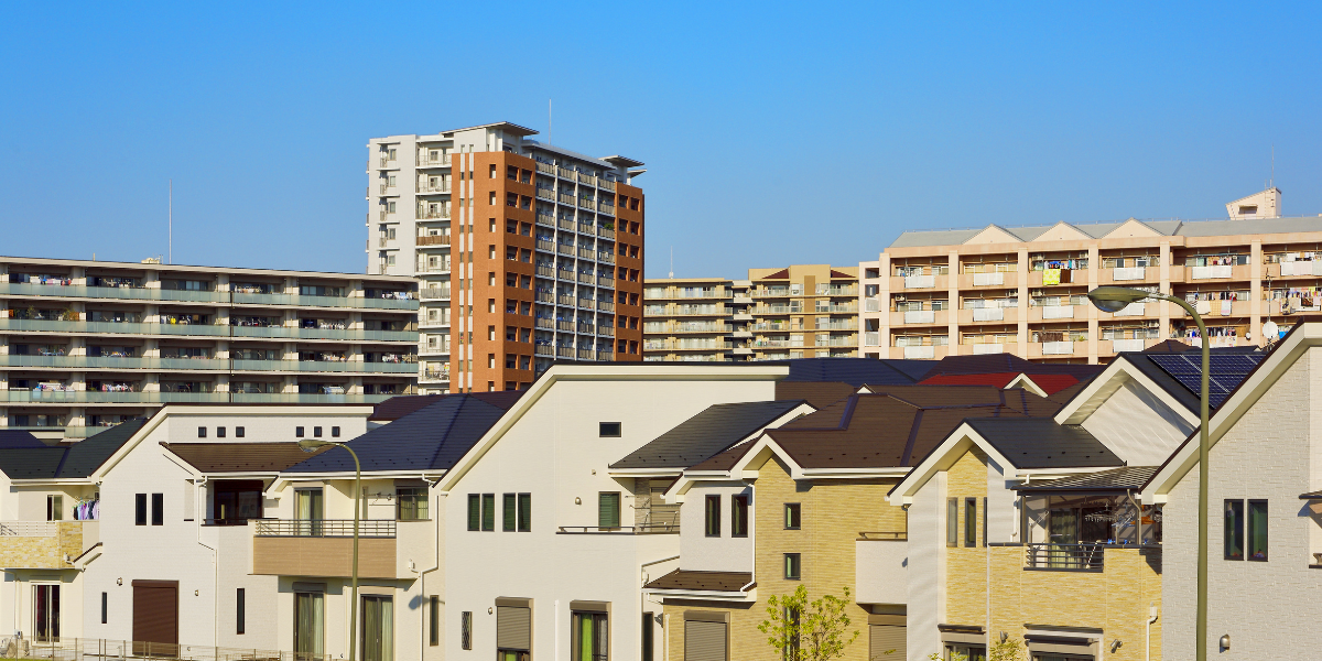 A Japanese urban neighborhood with both apartment buildings and detached houses. The diverse residential landscape reflects the varied contexts researchers encounter during home visit studies in Japan.