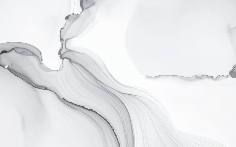 An abstract image of grey ink flowing across a white background. This represents the 'color' consideration, illustrating how an ink color interacts with the paper it is on.
